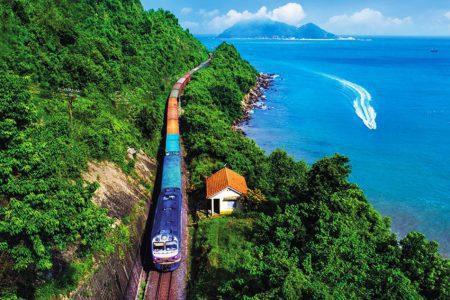 A train winding along the green coastline between Da Nang and Hue